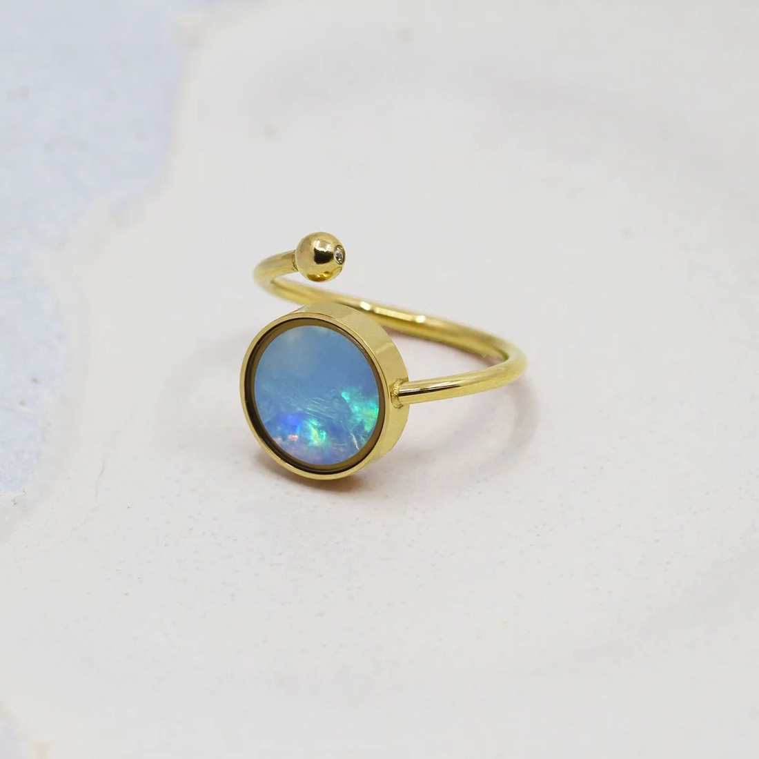 The Oli&J adjustable ring with a gold PVD finish over 316 stainless steel, its round bezel ready for a stone