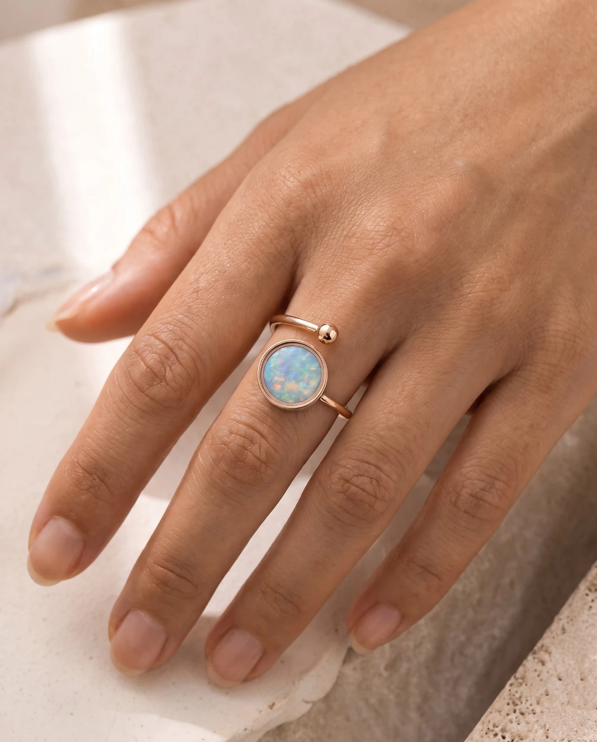 The Australian Opal Adjustable Ring in 18K rose gold plate, worn on a hand.