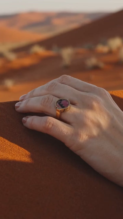 Australian rhodonite unisex ring worn on a hand in the outback at golden hour