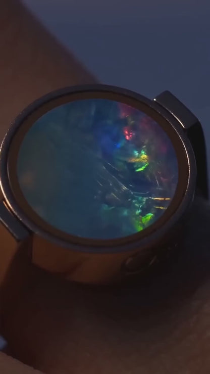 The Australian Opal Unisex Ring worn, its opal catching the light as the hand turns.