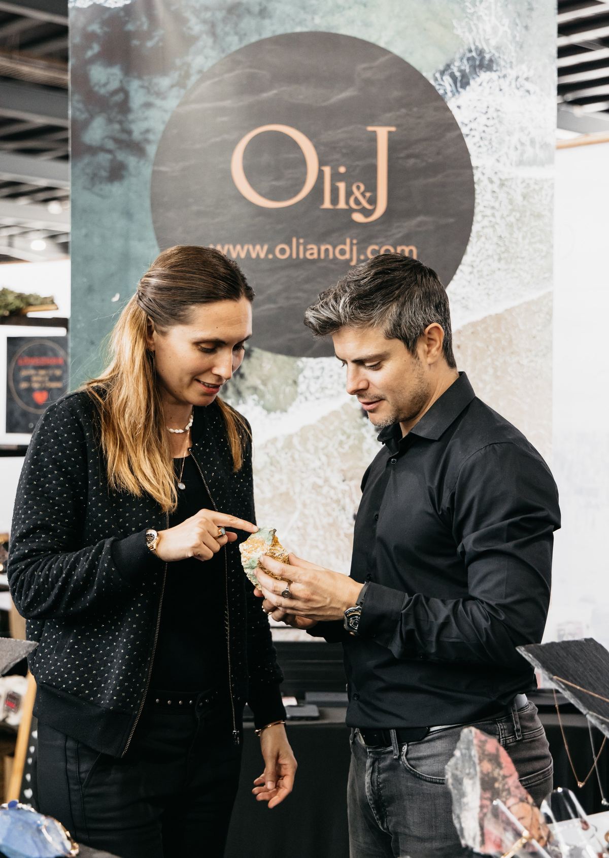Olivia and Juan, the makers behind Oli&J, examining a rough gemstone together.